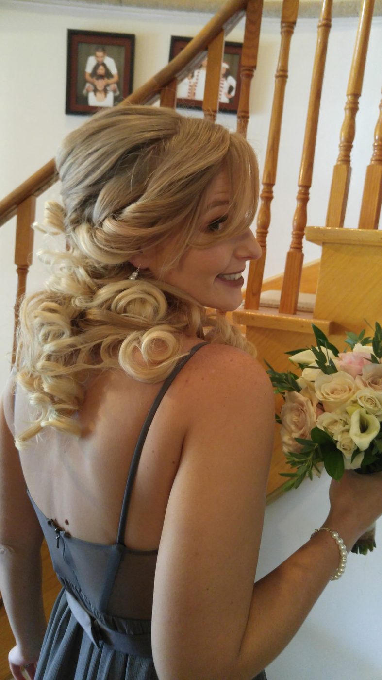 Bridesmaid with blonde hair in a swept-side curl set