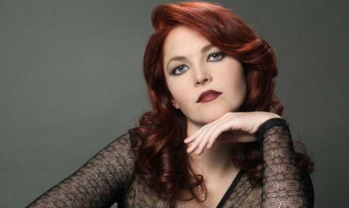 Studio portrait of deep red hair in soft vintage waves