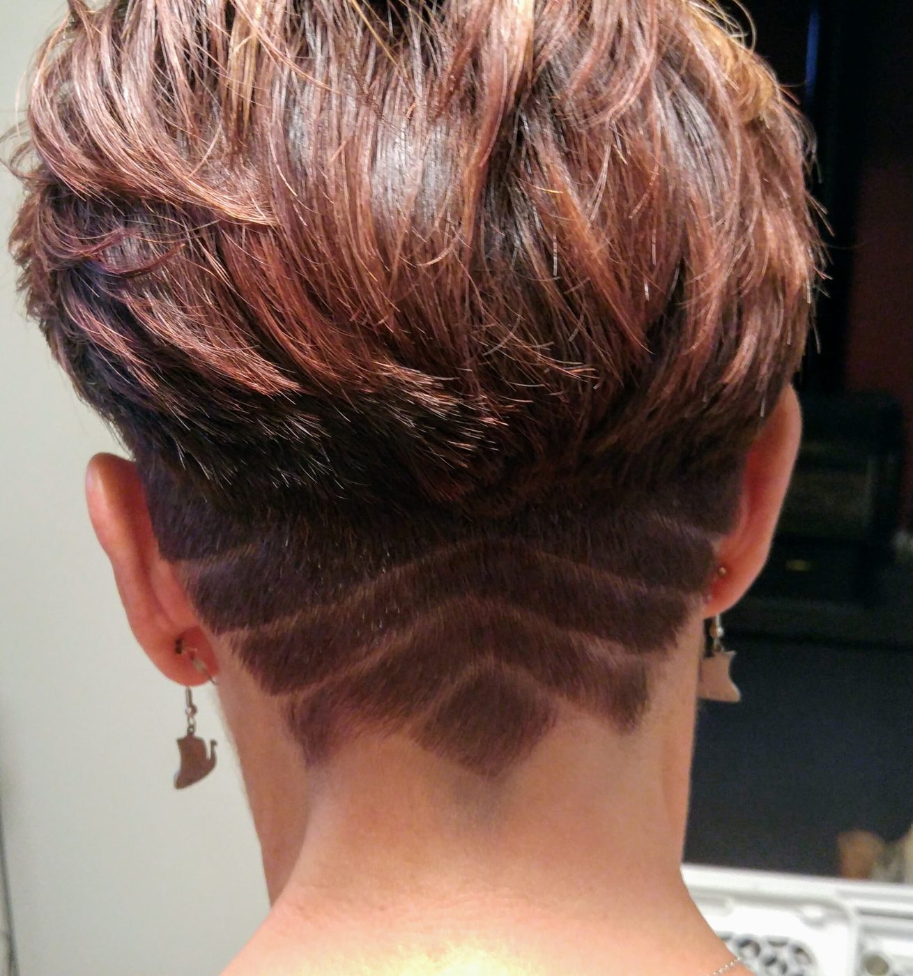Short cut with a carved undercut design and rose-gold highlights